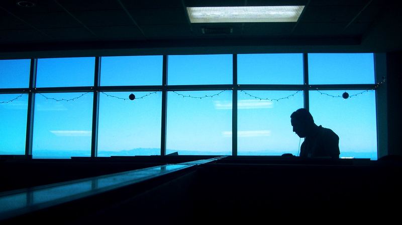 A person sitting quietly by a bright window