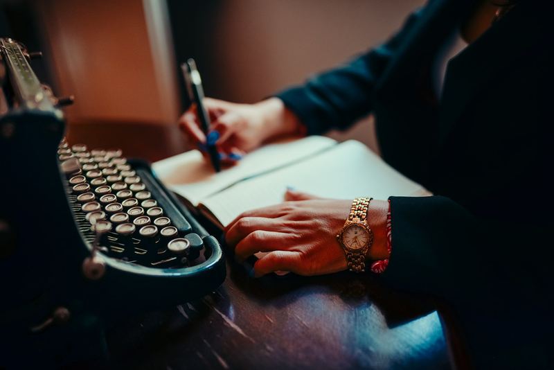 A person writing by hand at a desk